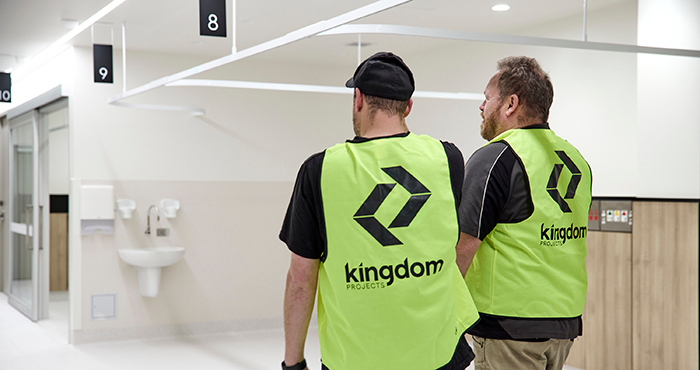 Kingdom Projects team member in high-visibility clothing conducting a final quality inspection of a hospital endoscopy recovery area before project handover.